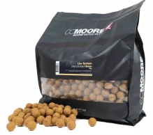 A black CC Moore packaging for Live System Shelf Life Baits. The bag is partially transparent, showing numerous round, brown baits inside. More baits are scattered in front of the bag. Perfect for maters, the package text reads 